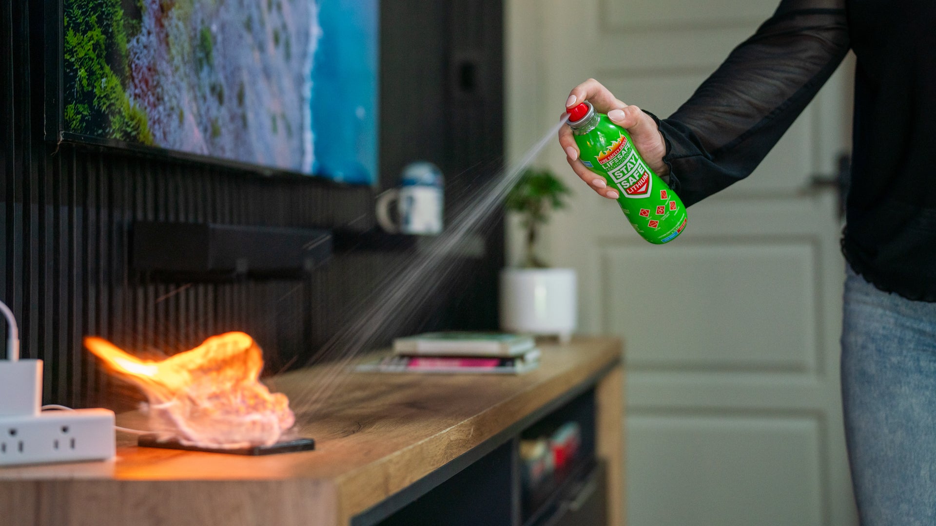 StaySafe Lithium being sprayed onto an electrical fire on a TV unit in a living room